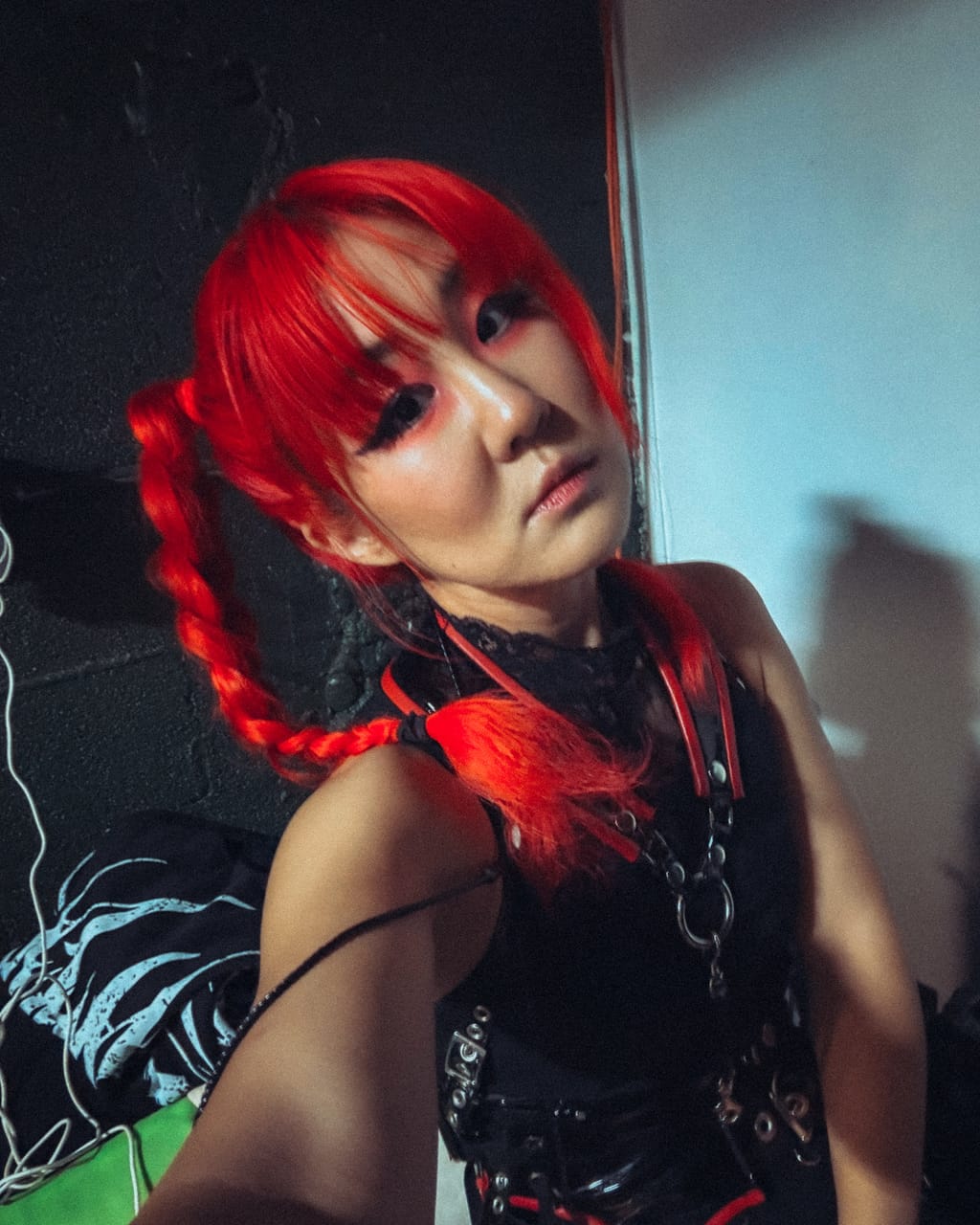 Grace Kelly of DEADGRACE takes a selfie backstage at the Mesa Theater in Grand Junction, red braids over her shoulder